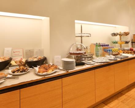 La sala de desayuno en el Best Western Hotel Major, acogedor y luminoso, que ofrece un rico buffet con una amplia variedad de pasteles, fruta, yogures, zumos de frutas, cereales, tostadas, huevos, tocino, embutidos y quesos.